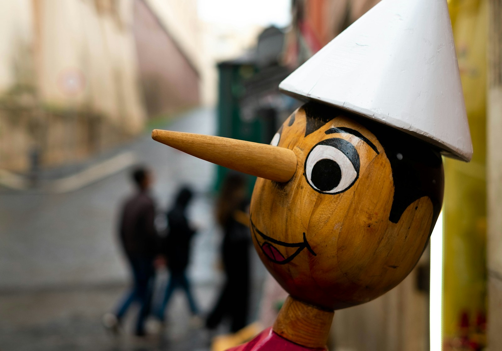 a wooden statue with a white hat on top of it