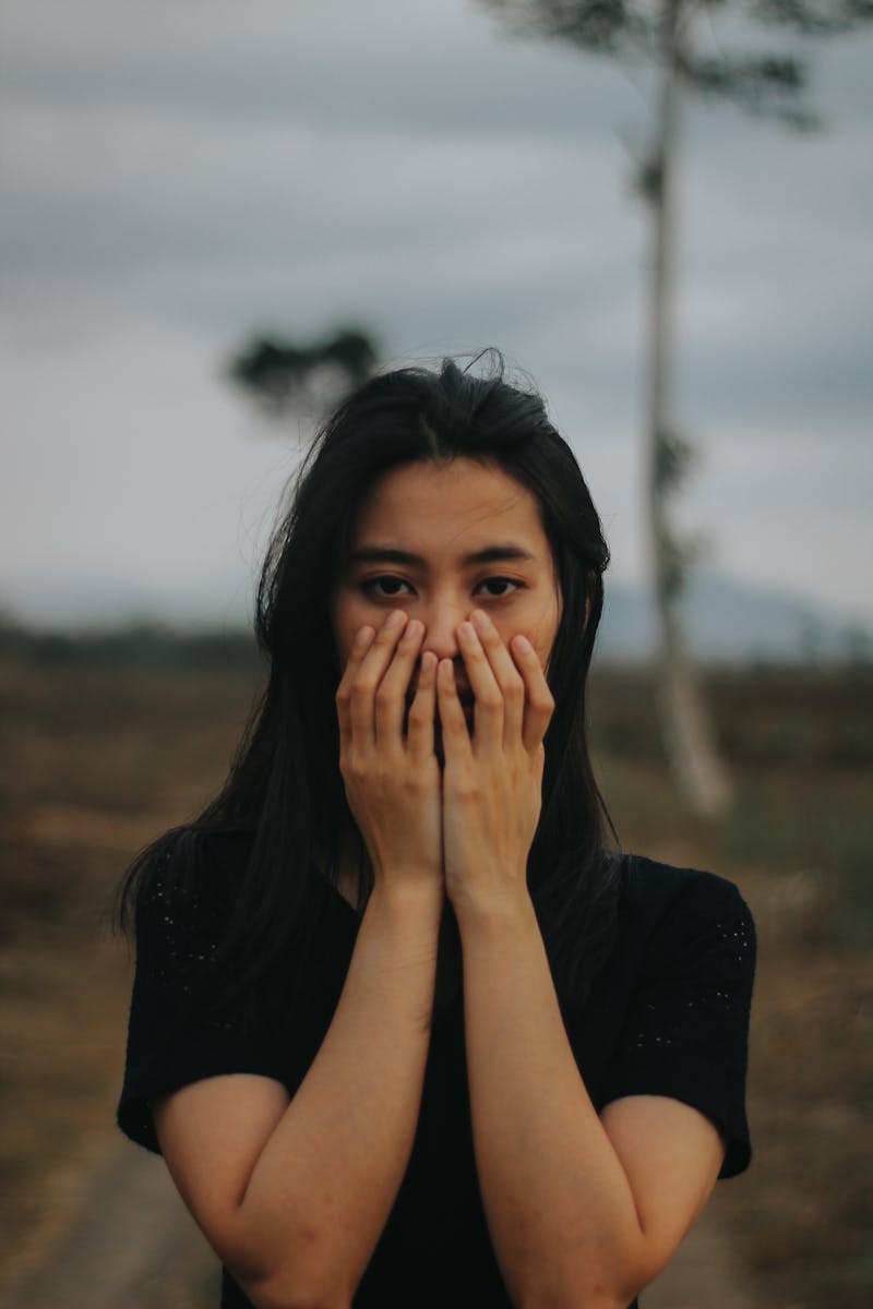 Woman Covering Her Face Using Both Hands